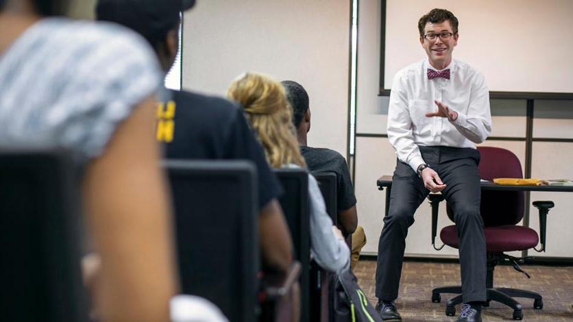 Professor talks to students from front of classroom